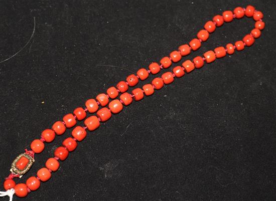 A coral bead choker necklace with coral set gilt metal clasp, 14in.